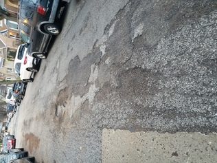 Repave street and repaint speedbumps on 6000 block of North Menard